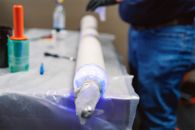 A plumber with new techniques for repairing a sewer pipe.