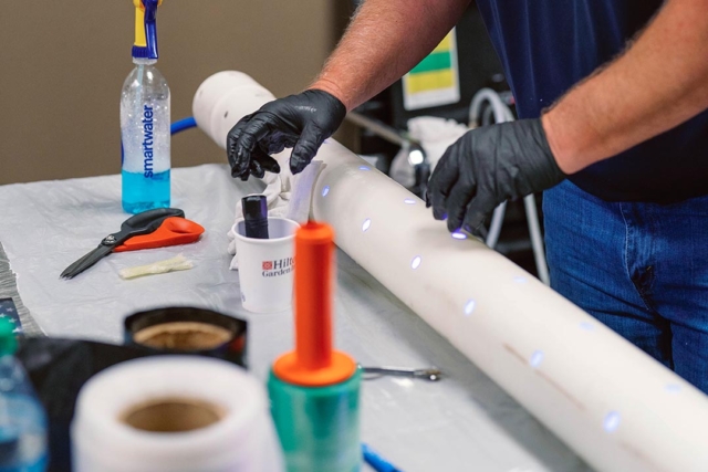 A plumber looking at new trenchless sewer repair methods