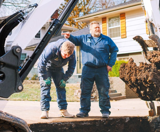 Bright Side Plumbing crew excavating a sewer line at a Kansas City home