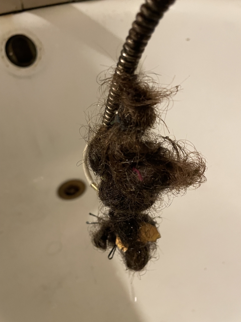 Hair clog pulled from a bathtub drain with a cable snake by Bright Side Plumbing