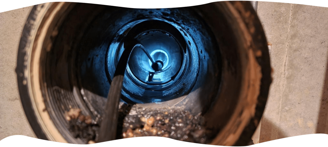 Sewer camera with LED light entering a pipe through a cleanout during a Bright Side Plumbing inspection